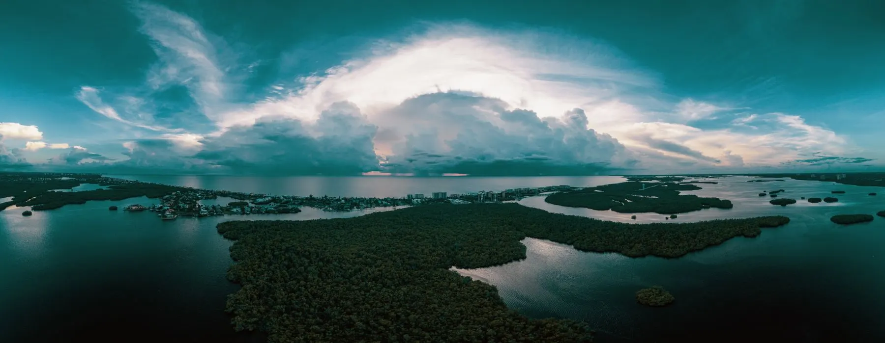 Aerial view of the Bonita Springs coastline and waterways under dramatic clouds