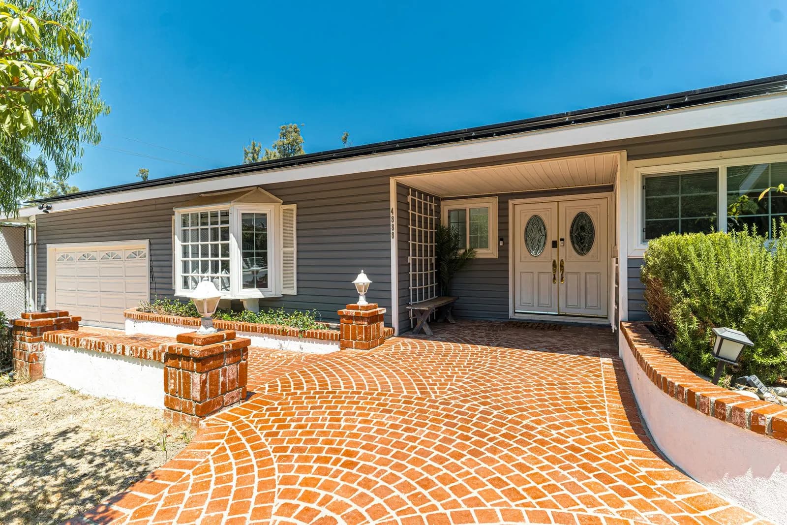 Brick paver entry walk laid in a fan pattern leading to a front door