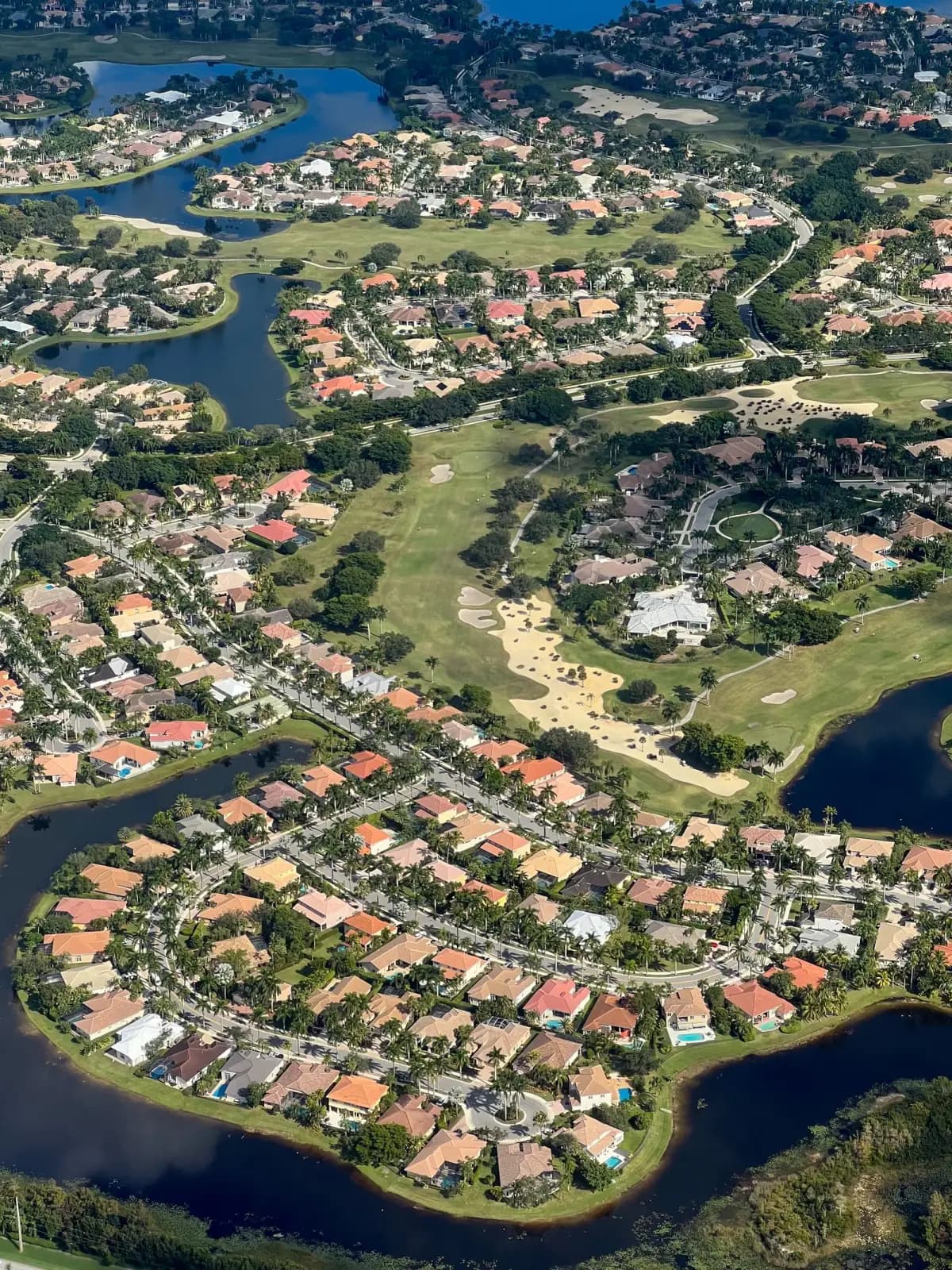 Aerial view of a Florida community built around lakes and a golf course