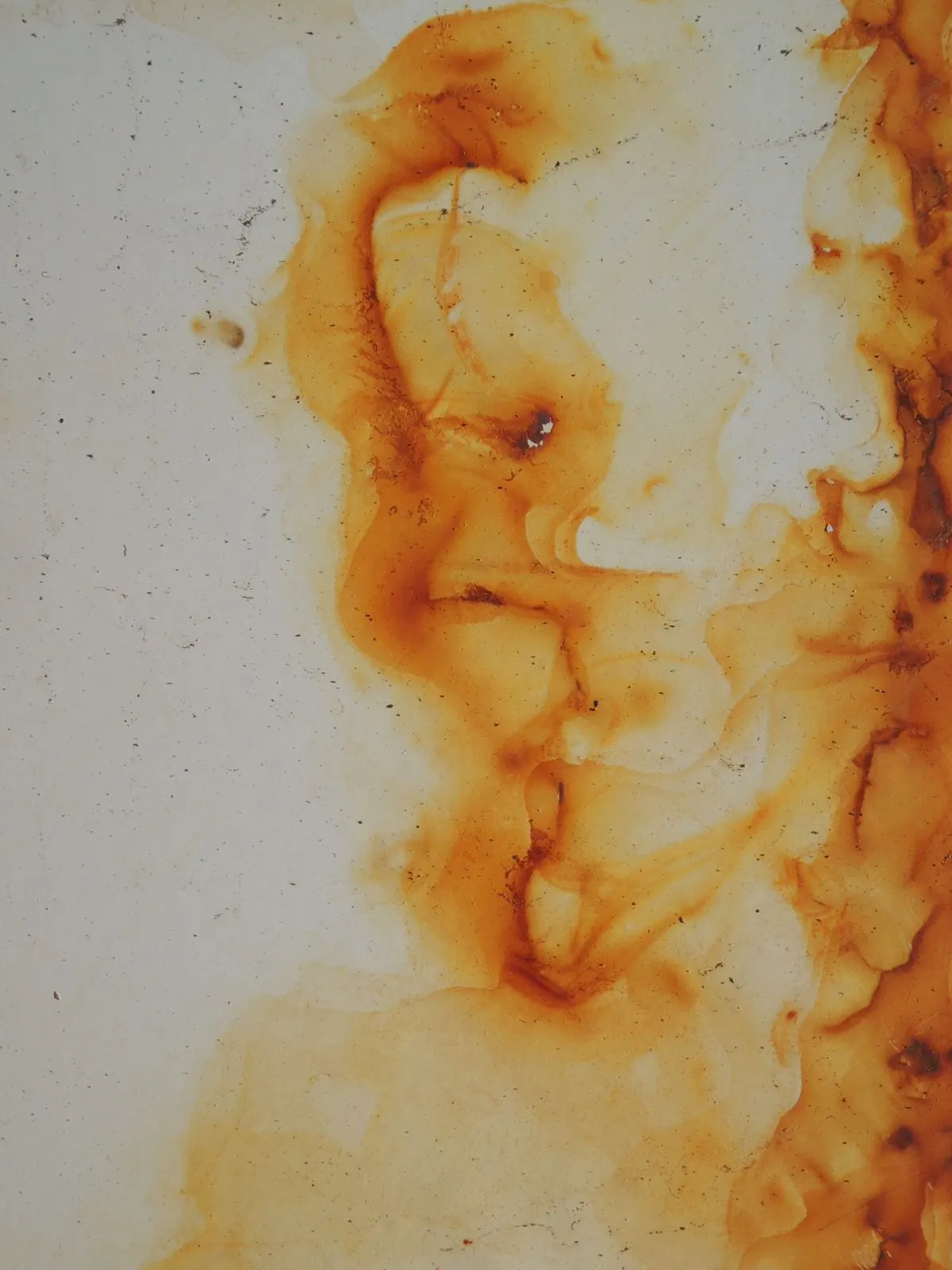 Orange rust stains spreading across a white surface